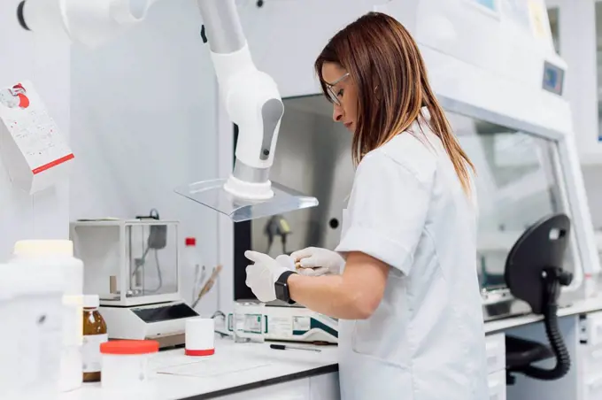 Confident female scientist working at laboratory
