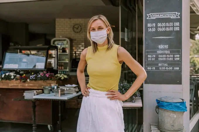 Portrait of confident cafe owner wearing face mask