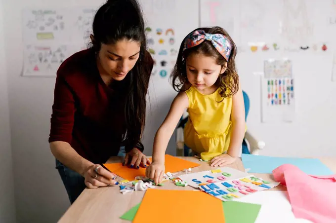 Mother and daughter doing crafts at home