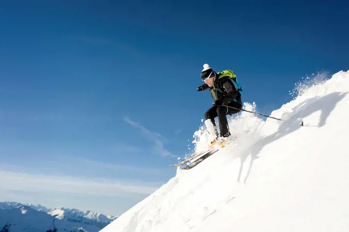 Austria, Man skiing on mountain at Alpbachtal
