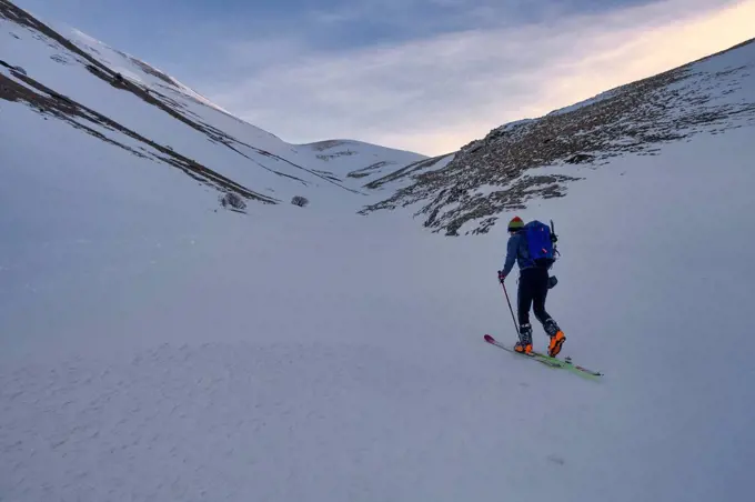 Young man cross-country skiing on Sibillini mountain at sunset, Umbrian, Italy