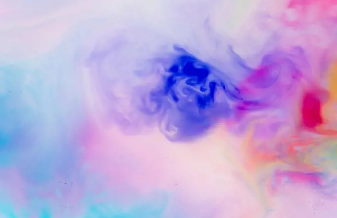 Full frame of blue, purple and red liquids mixing together
