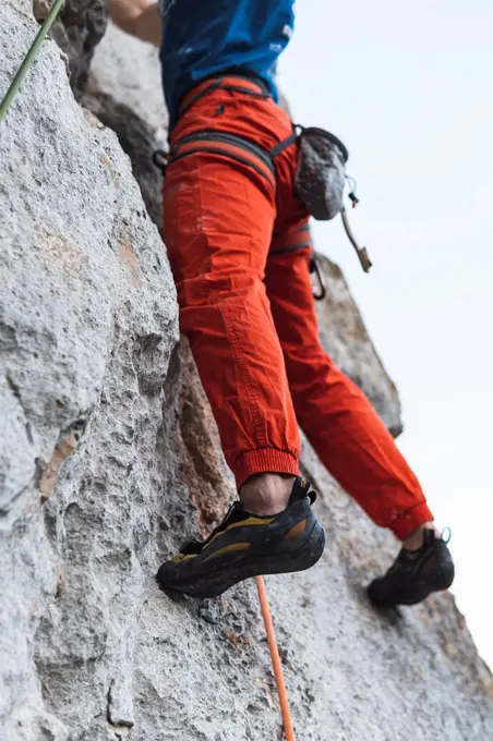 Sportsman climbing rocky mountain