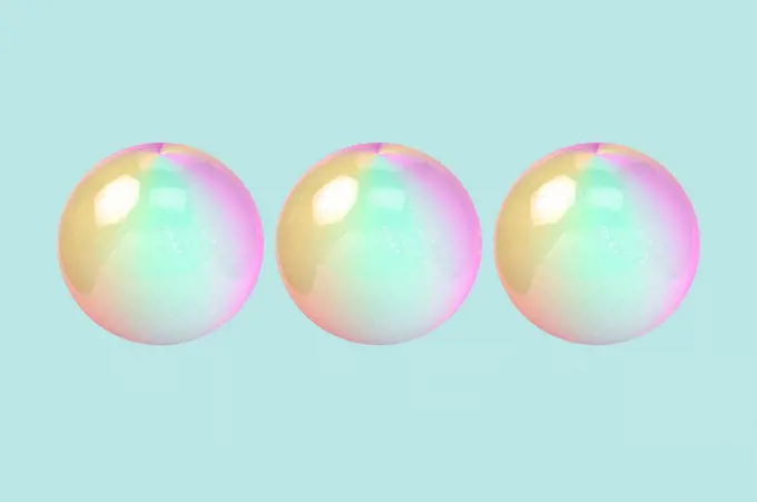 Three dimensional render of three bubbles against green background