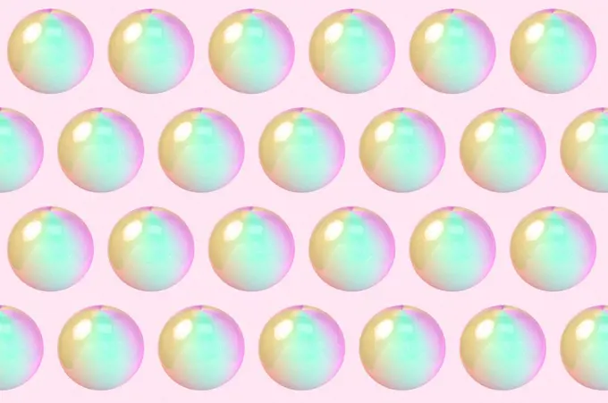Three dimensional pattern of rows of bubbles against pink background