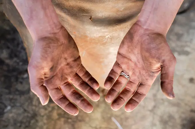 Dirty hands of male blacksmith at workshop