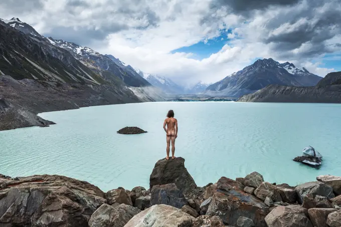 New Zealand, Canterbury, Rear view of naked man looking at Tasman Lake