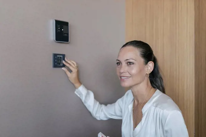 Female professional adjusting smart switch