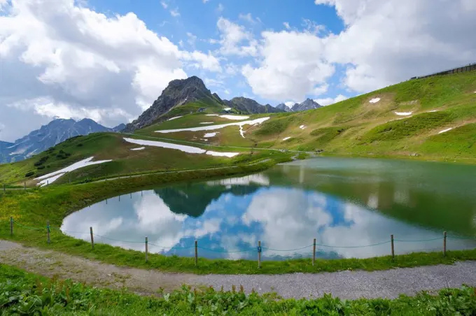 Scenic view of small reservoir in Kleinwalsertal valley during summer