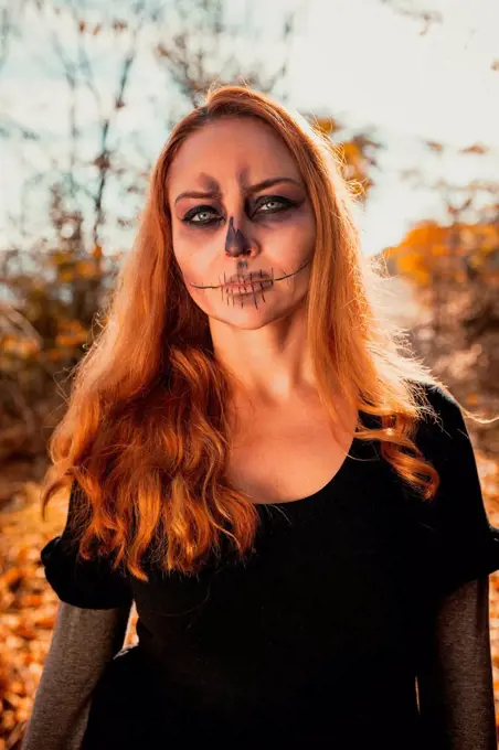 Woman with Halloween make-up in forest