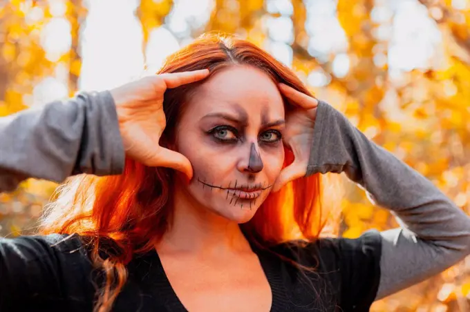 Woman with Halloween make-up in forest