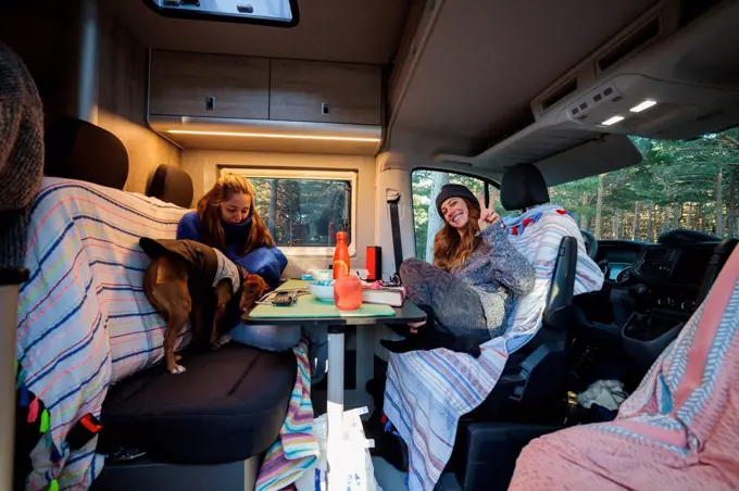 Friends having breakfast in camper van
