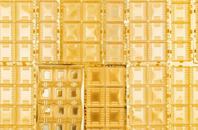 Full frame of gold colored plastic packaging