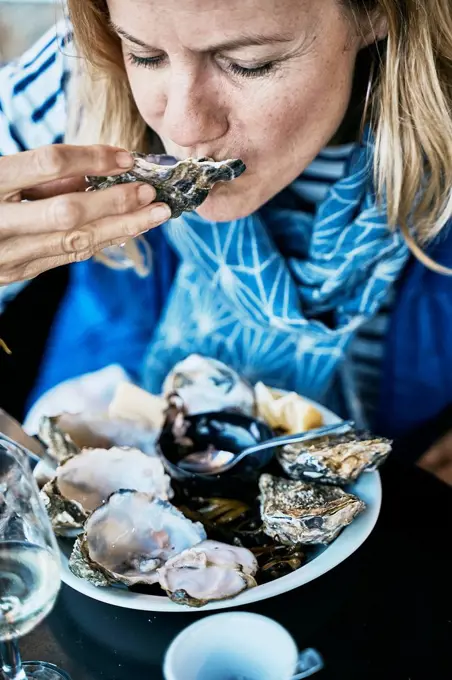 Tourist eating oysters at vacations
