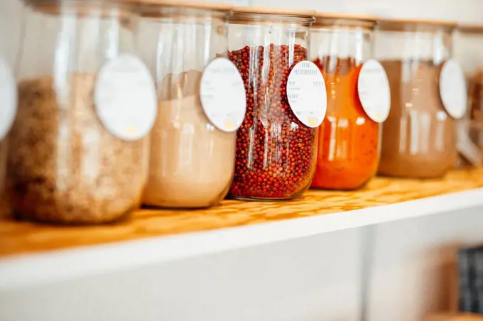 Ingredient jars with labels on shelf at cafe