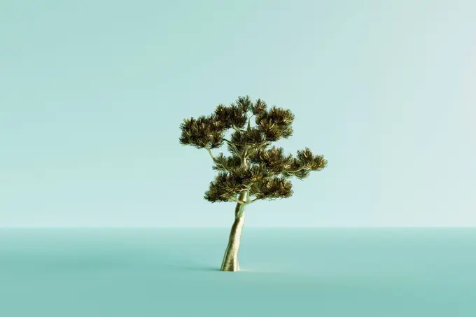 Three dimensional render of lone gold colored tree standing against blue background