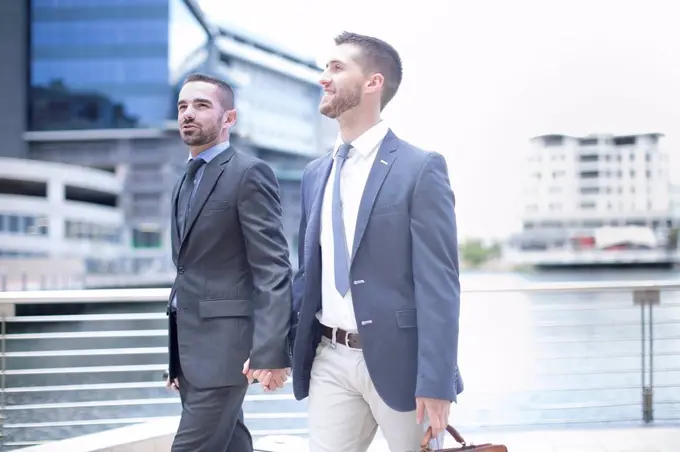 Gay couple walking with business suits