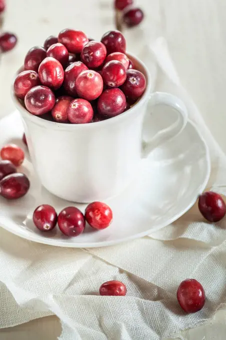 Fresh cranberries in a coffee cup