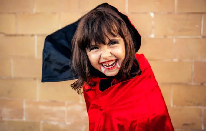 Portrait of little girl masquerade as vampire