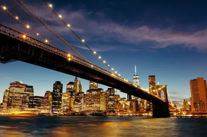 USA, New York, New York City, Manhattan, Brooklyn Bridge and skyline during a summer night