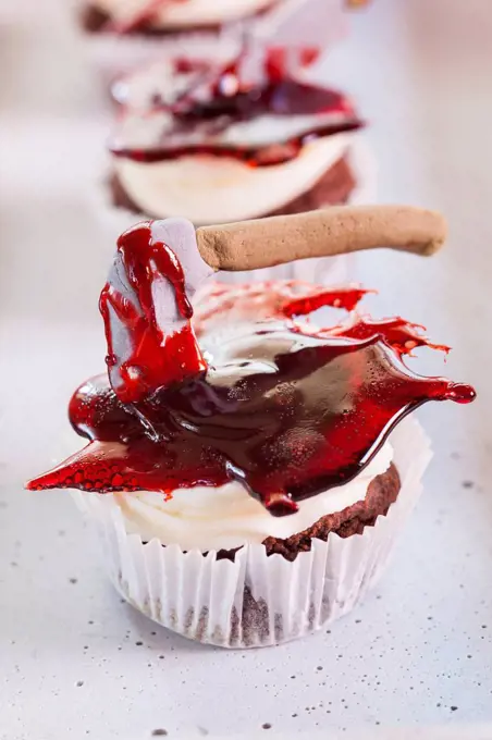 Halloween cupcakes with axe in jelly blood