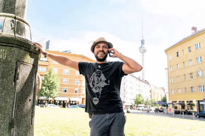 Germany, Berlin, smiling man on the phone with television tower in the background