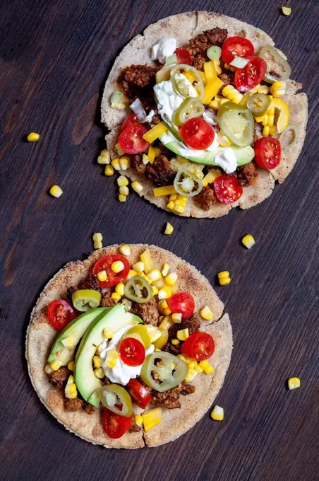 Two Mexican Tortillas with mincemeat, avocado, tomato, corn, Jalapeno pepper and sour cream