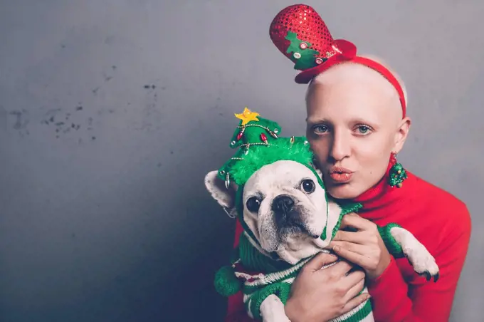 Portrait of woman and her French bulldog at Christmas time