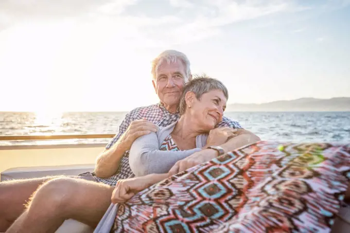 Affectionate couple on a boat trip at sunset