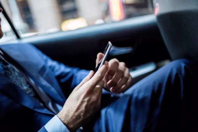 Businessman using smart phone, close up