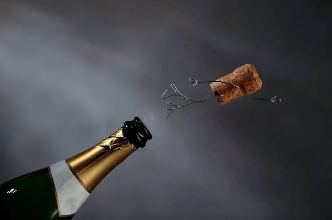 Champagne cork manikin in the air