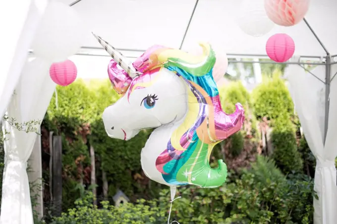 Decoration with unicorn balloon and lampions in a garden