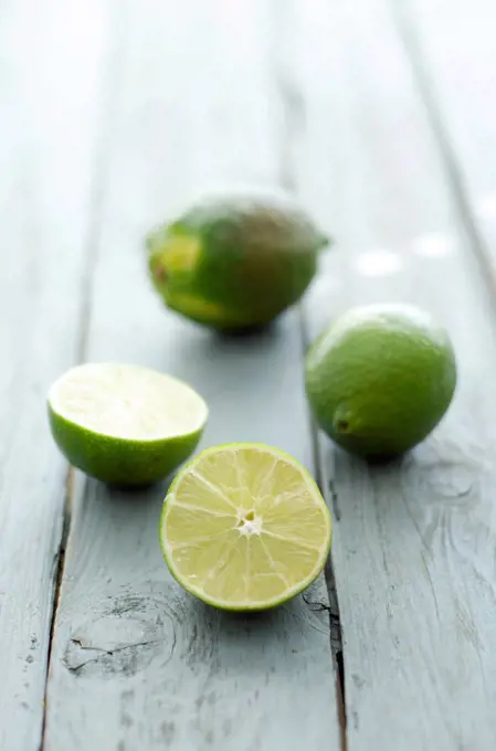 Limes on wooden table, close up