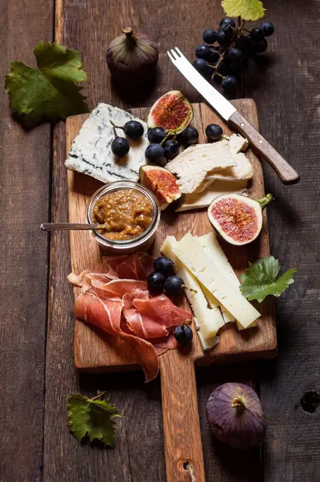 Cheese platter with fruits and fig mustard