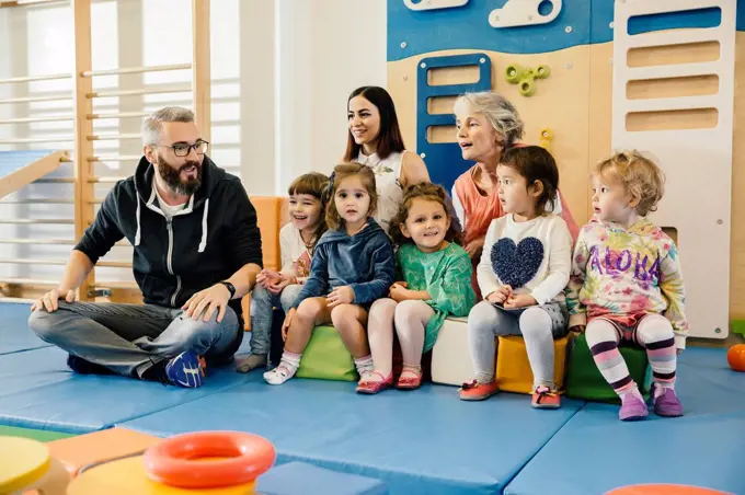 Group of children and teachers in gym room in kindergarten