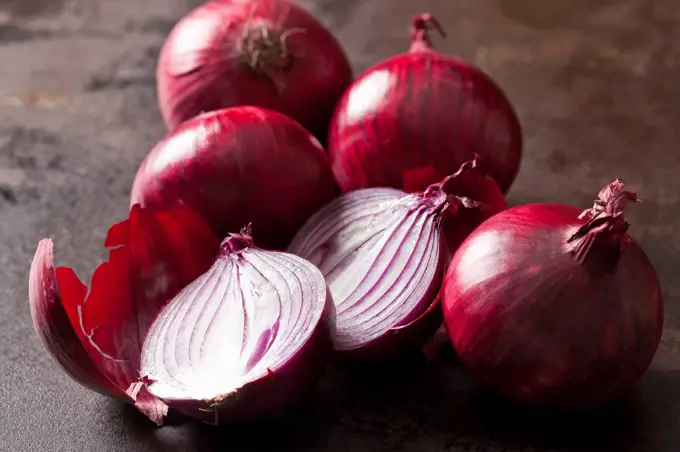 Whole and sliced red onions