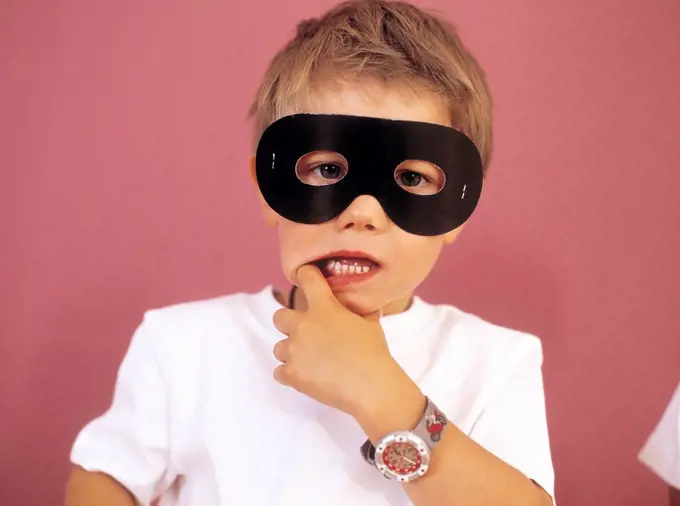 Portrait of little boy wearing black eye mask