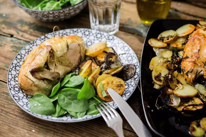 Roasted chicken with potatoes and basil
