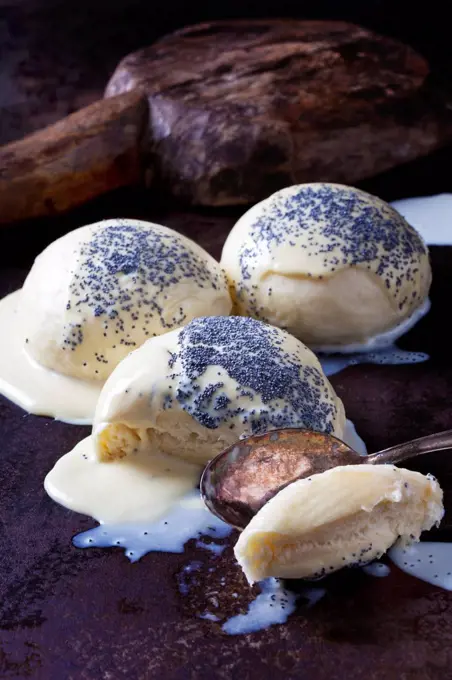 Yeast dumplings with vanilla sauce sprinkled with poppy seed