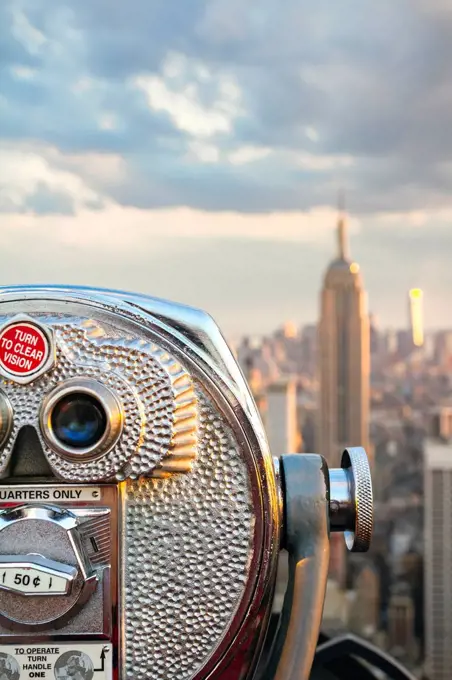 USA, New York, Manhattan, Close up of telescope, Empire State Building in background