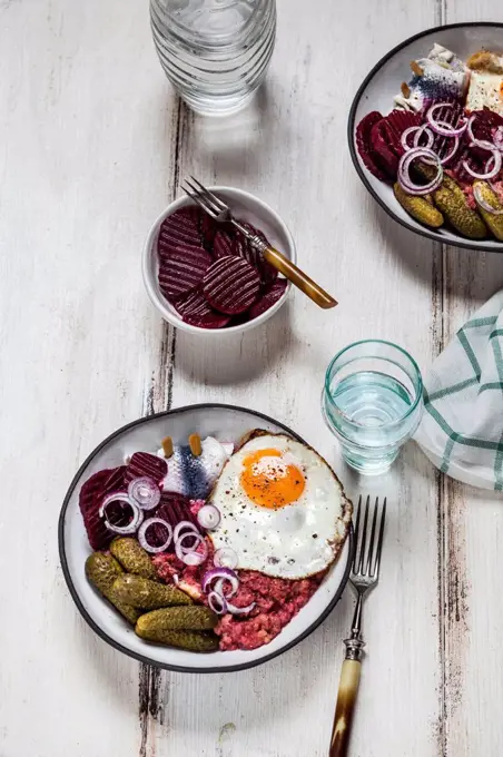 Labskaus, rollmops, pickled gherkin, beetroot salad, onion and fried egg