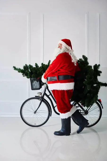 Santa Claus carrying with bicycle