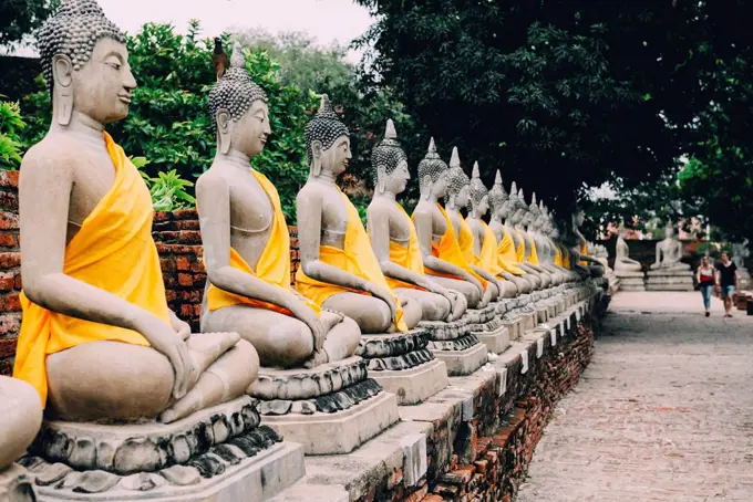 Thailand, Bangkok, Ayutthaya, Buddha statues in a row in Wat Yai Chai Mongkhon