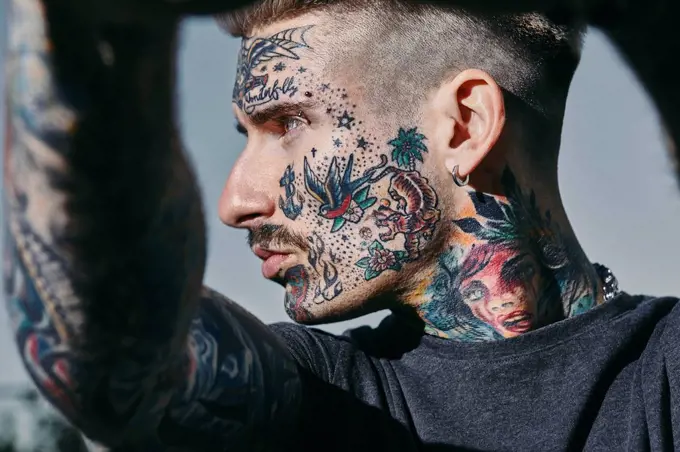 Portrait of tattooed young man outdoors