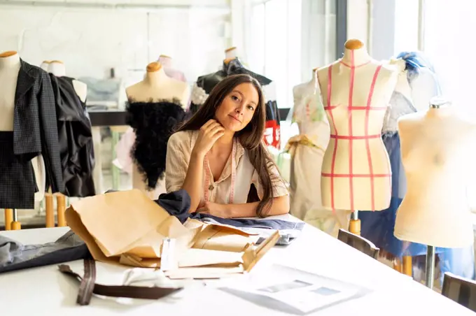 Young fashion designer working in her studio