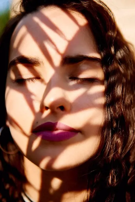 Young woman's face in sunlight