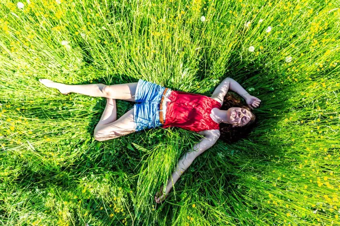 Young woman relaxing in meadow
