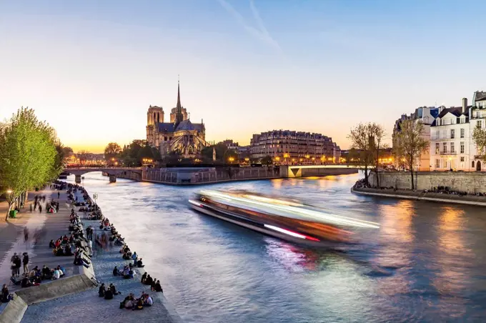 France, Paris, Tourist boat on Seine river with Notre Dame cathedral in background