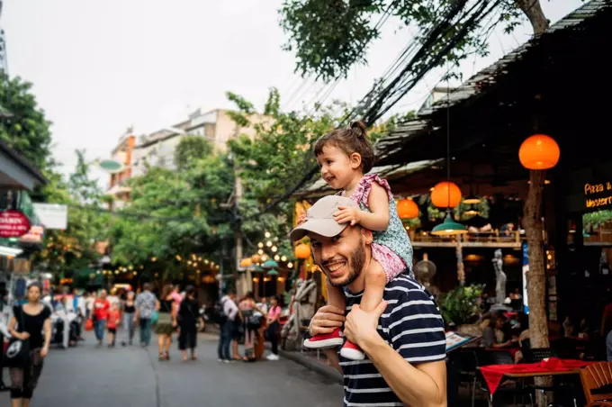 Thailand, Bangkok, portrait of smiling father and daughter on Khao San Road