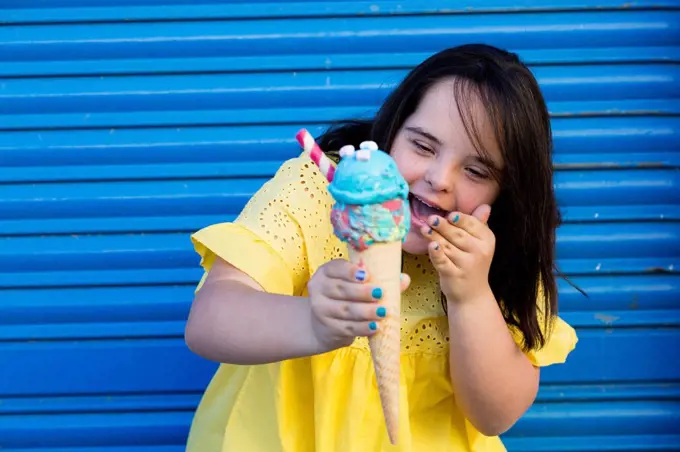 Teenager girl with down syndrome enjoying an ice cream